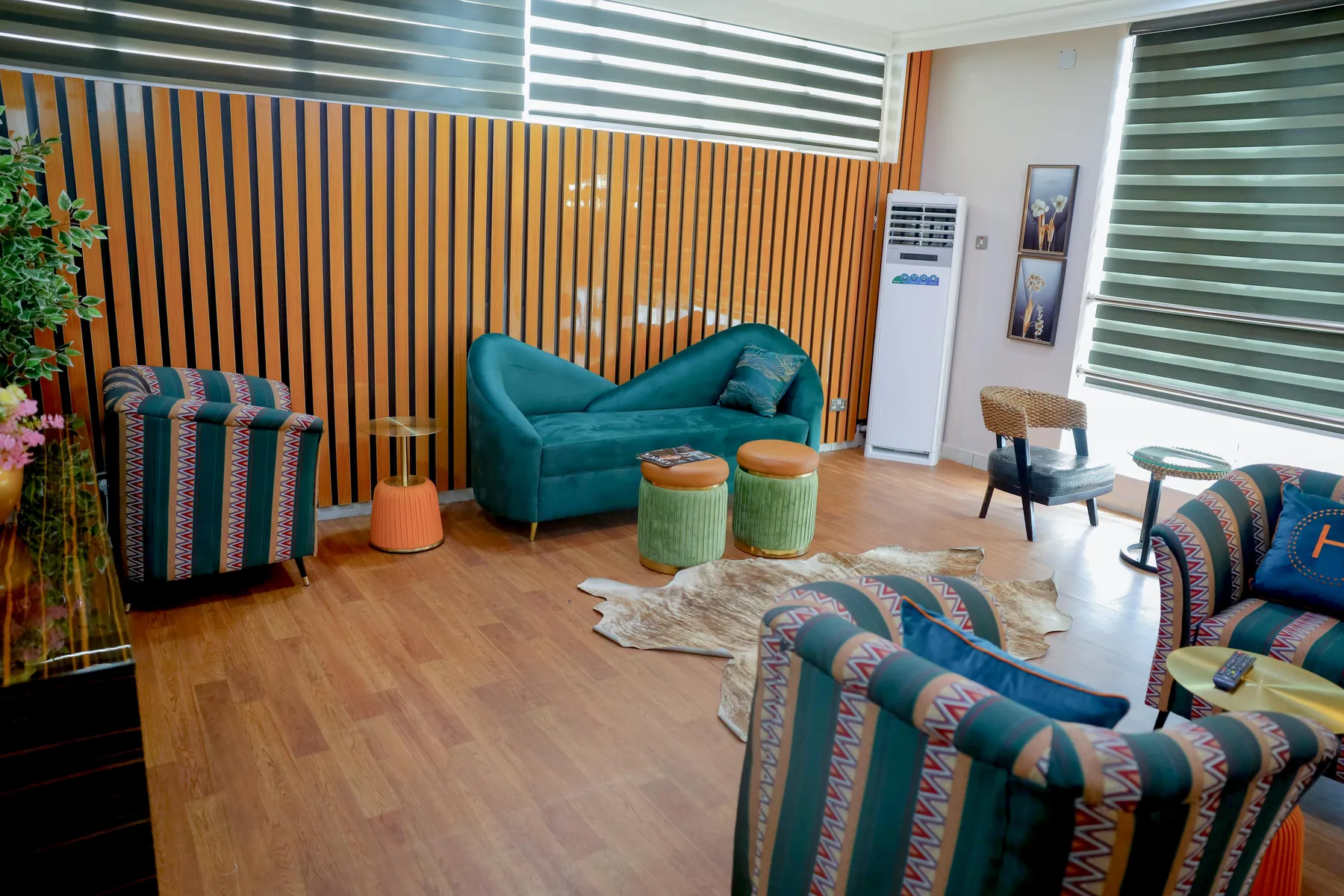 A warm lounge with soft seating inside Glamour Lounge